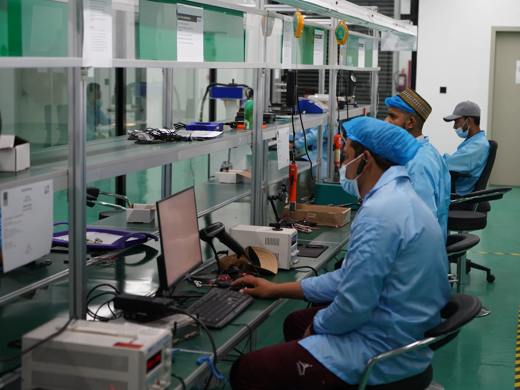 Technicians assembling electronics on the Future AI production line